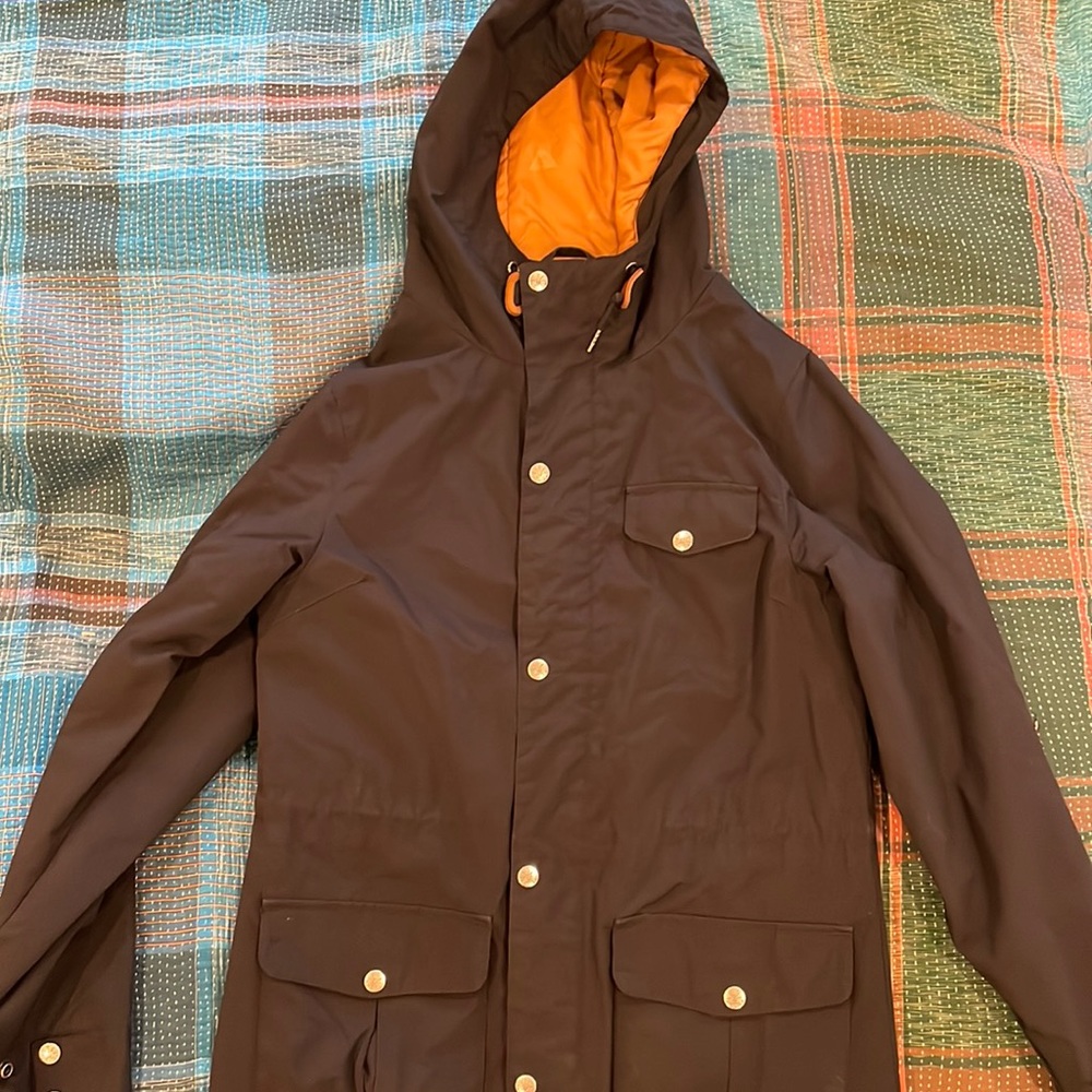 Poler zip and snap women’s insulated rain jacket, black with brown inside, small